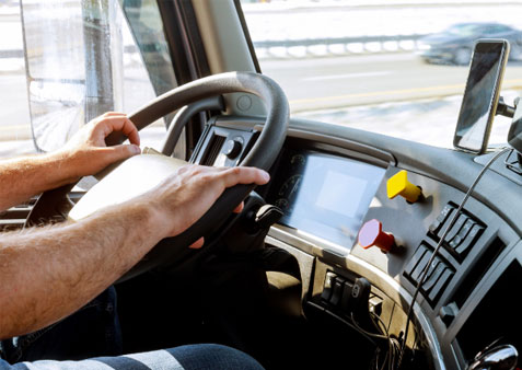 Photo of male driving a truck on the highway